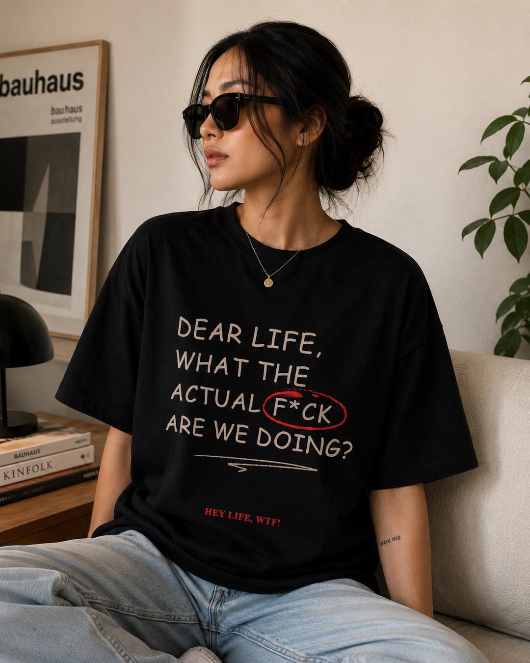 Black Dear Life What the Actual F*ck Are We Doing statement T-shirt on a seated model