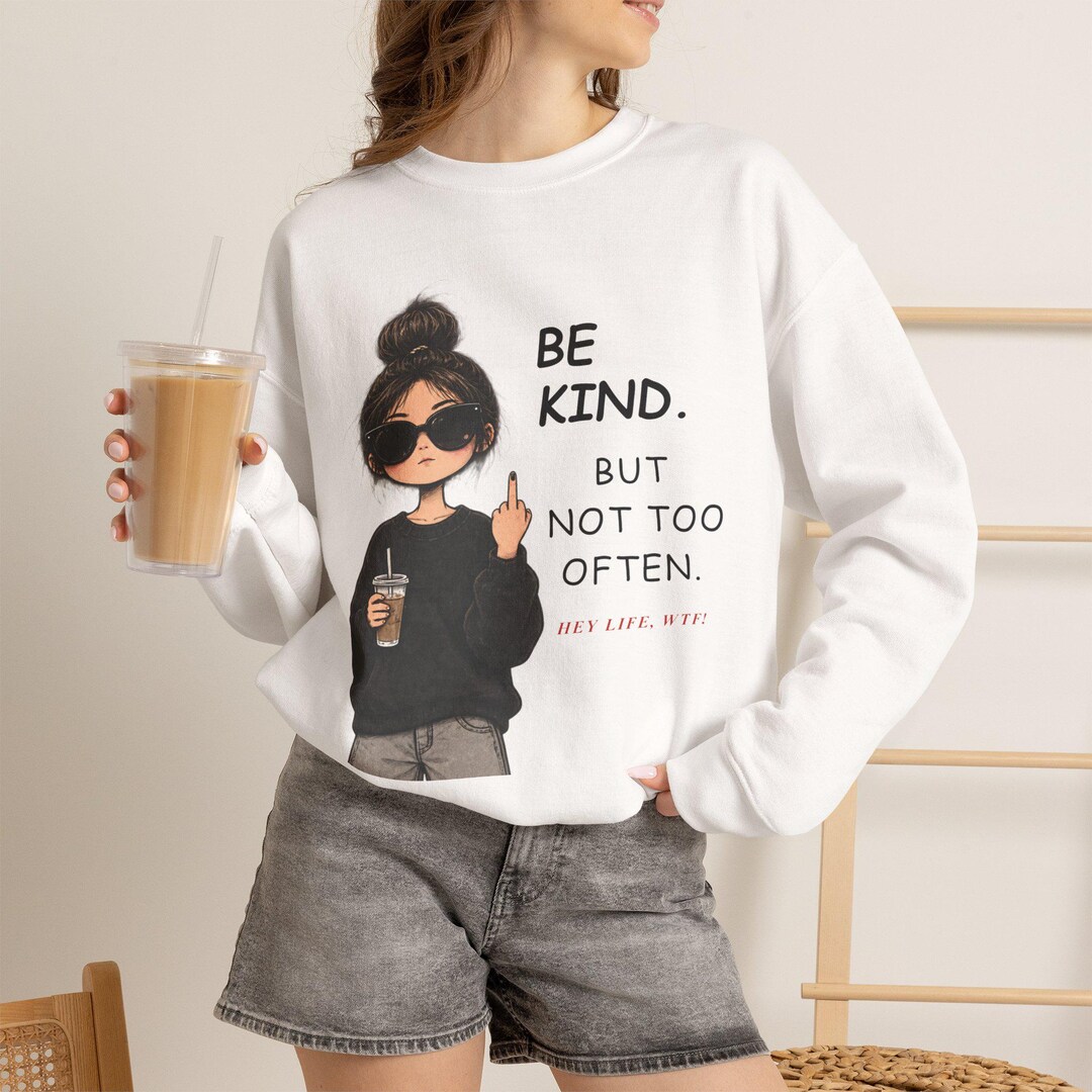 White Be Kind But Not Too Often sweatshirt with a woman holding coffee